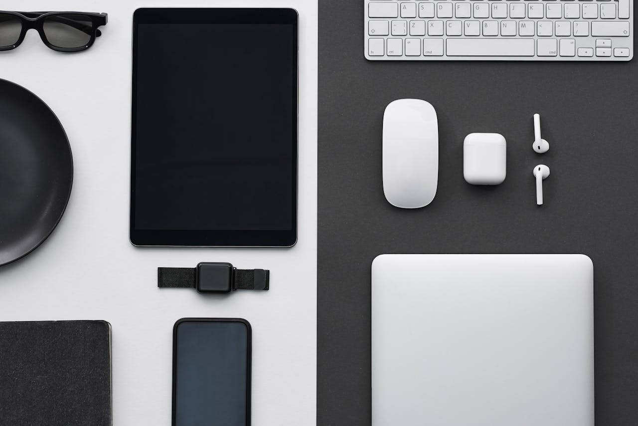 about-01 Stylish flatlay of modern tech gadgets including tablet, smartphone, smartwatch, and accessories.