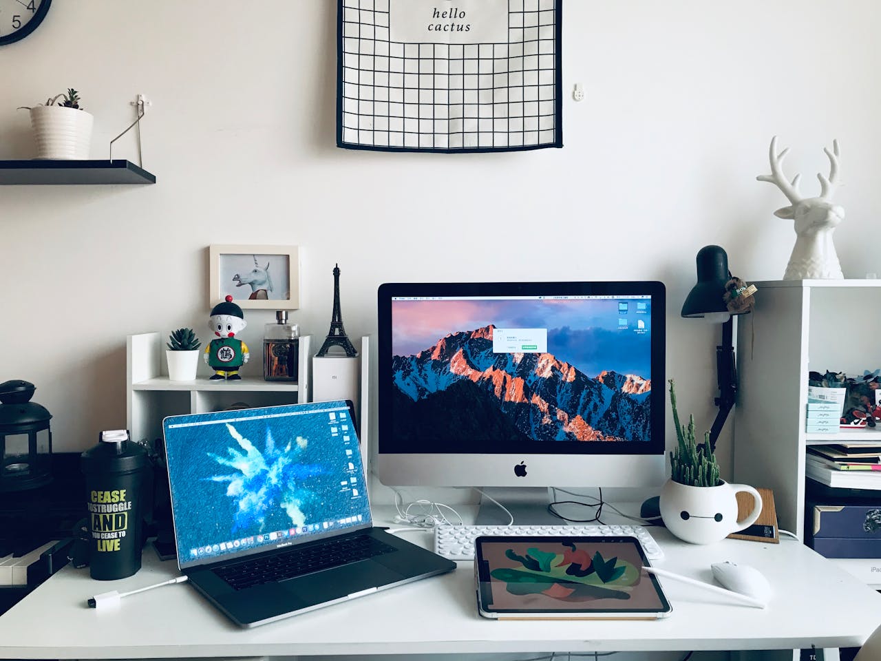 gallery-1 A stylish home office featuring a laptop, desktop, and artistic decor elements for a productive workspace.
