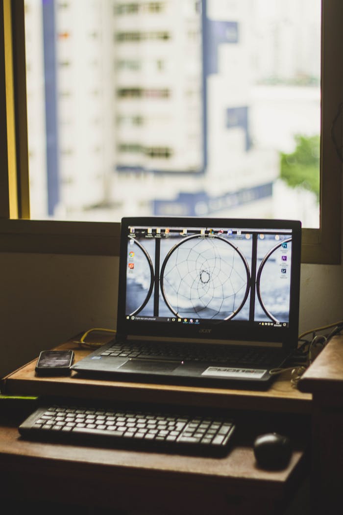 The Art of Drawing Readers In: Your attractive post title goes here Cozy indoor workspace featuring a laptop and window view of city buildings.